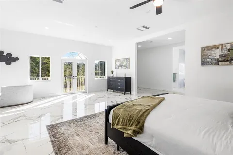 a spacious bedroom with a large bed and a couch