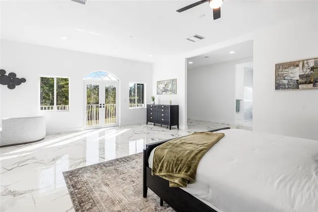 a spacious bedroom with a large bed and a couch