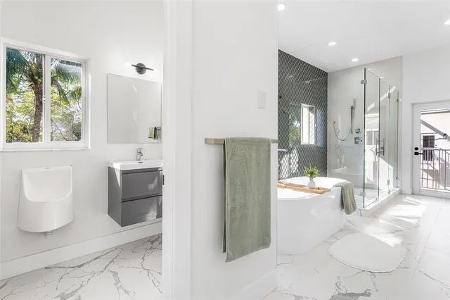 a bathroom with a tub sink and toilet