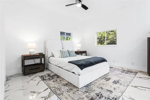 a bedroom with furniture and a window