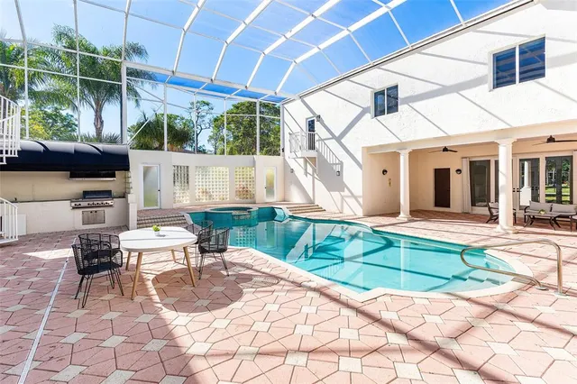 a view of a house with backyard porch and sitting area