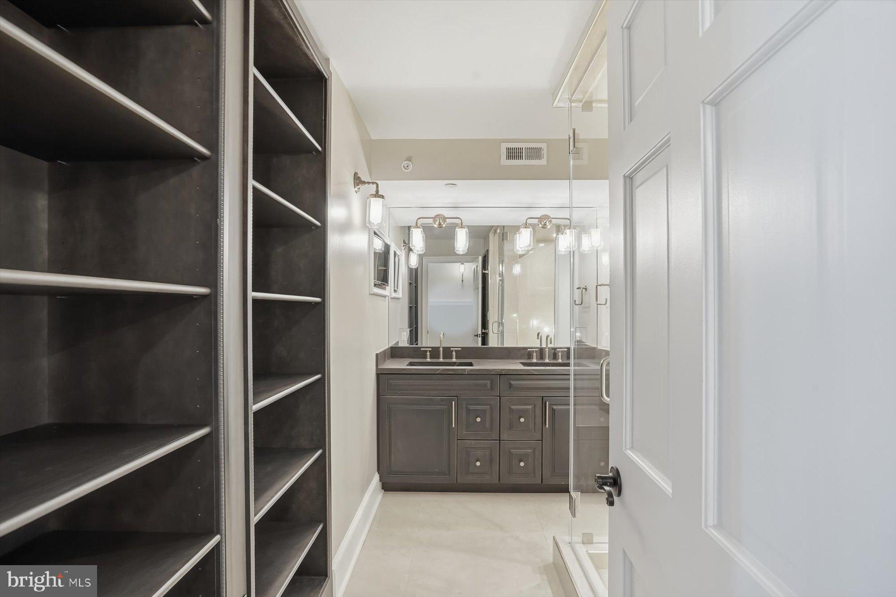 701 Pennsylvania Avenue Northwest, Unit PH21 Washington, DC 20004 - Photo 12 of 18 a kitchen with stainless steel appliances a stove and a refrigerator