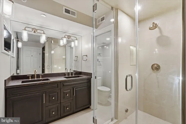 a bathroom with a granite countertop sink mirror and shower