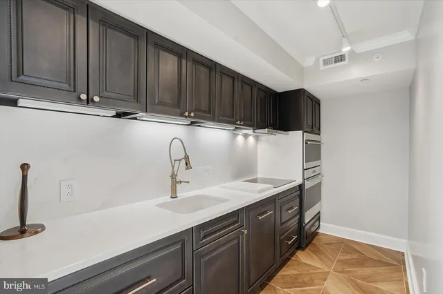 a kitchen with a sink and cabinets