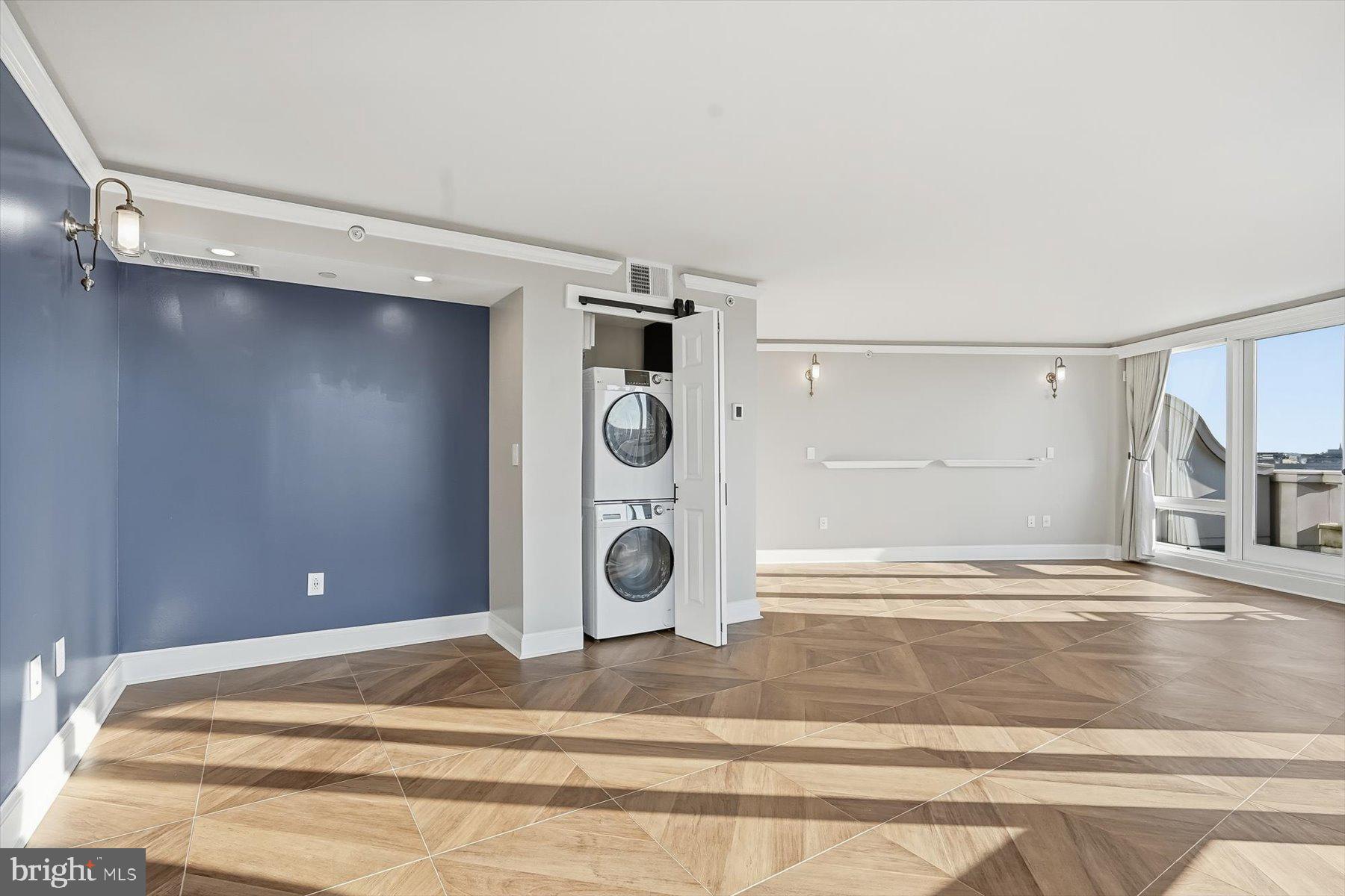 701 Pennsylvania Avenue Northwest, Unit PH21 Washington, DC 20004 - Photo 8 of 18 a view of a livingroom with an empty space and a ceiling fan