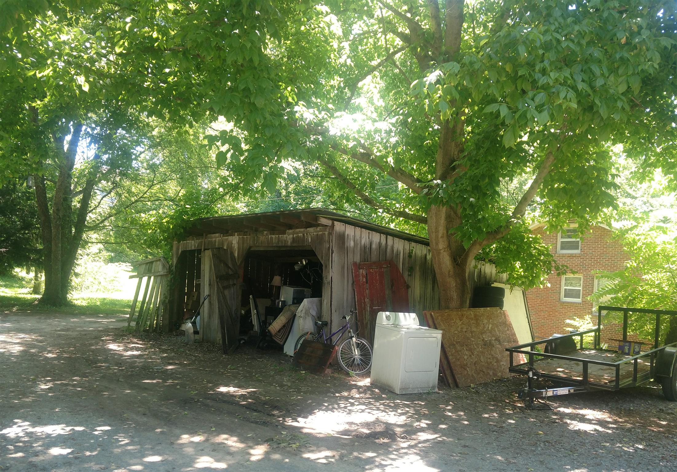 3580 Bell Road Nashville, TN 37214 - Photo 11 of 12 a view of a patio with table and chairs with wooden fence and large trees