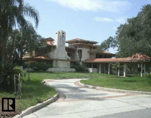 1028 Riverside Ridge Road Tarpon Springs, FL 34688 - Photo 1 of 1 Exterior Front - Circular drive, massive fireplace
