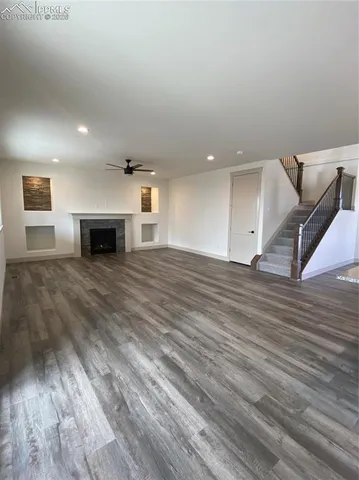 a view of a room with wooden floor and bench