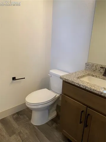 a large kitchen with granite countertop a sink and white cabinets