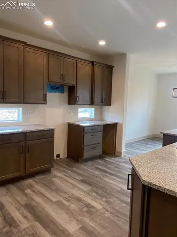 a view of a room with wooden floor and windows
