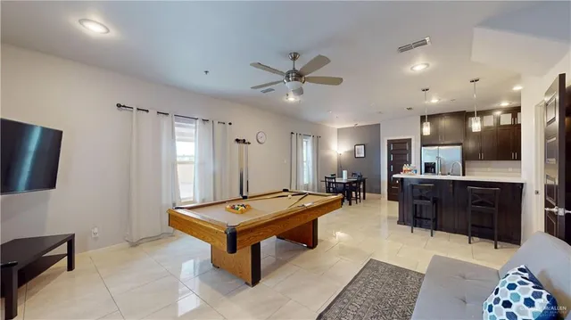a living room with stainless steel appliances kitchen island granite countertop furniture and a couch