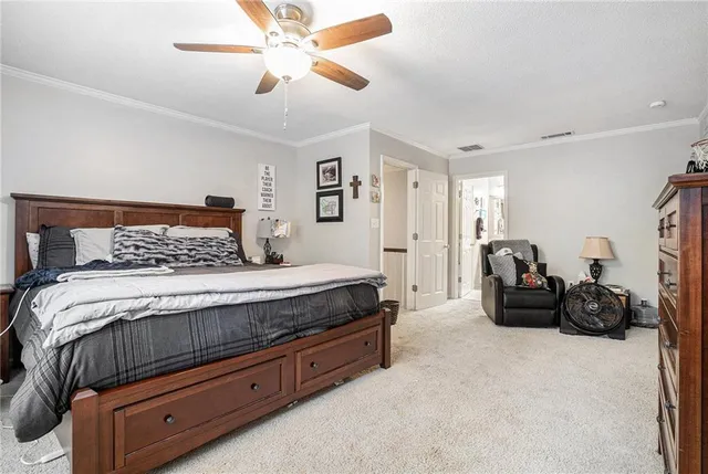 a bedroom with a bed and ceiling fan