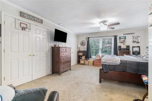 a living room with furniture a flat screen tv and large window