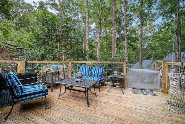 a view of a roof deck with furniture