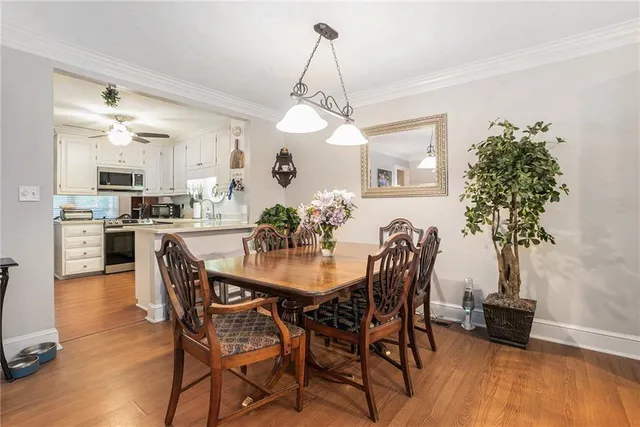 a view of a dining room with furniture and wooden floor