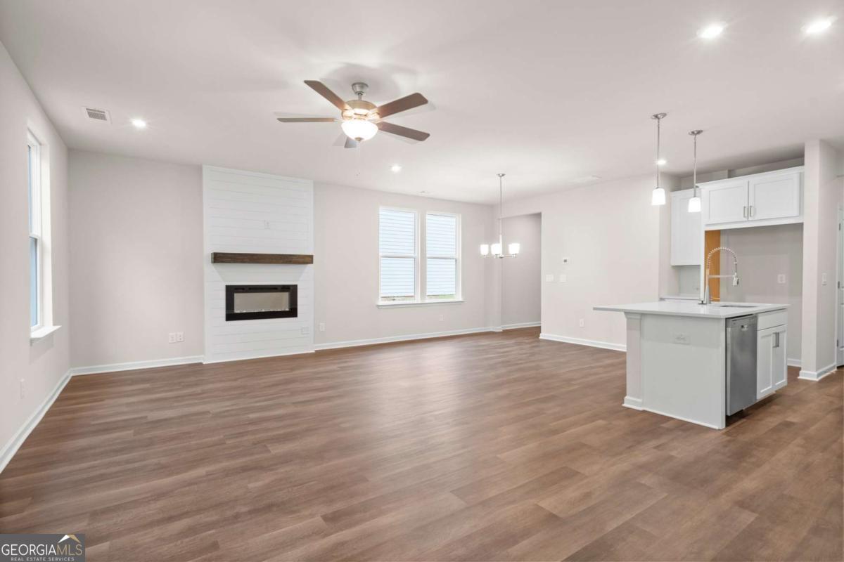 706 Smokey Quartz Way Kennesaw, GA 30144 - Photo 11 of 35 a view of an empty room with window and wooden floor