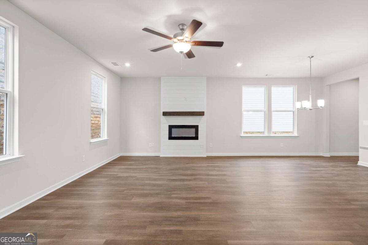 706 Smokey Quartz Way Kennesaw, GA 30144 - Photo 12 of 35 a view of an empty room with window and wooden floor