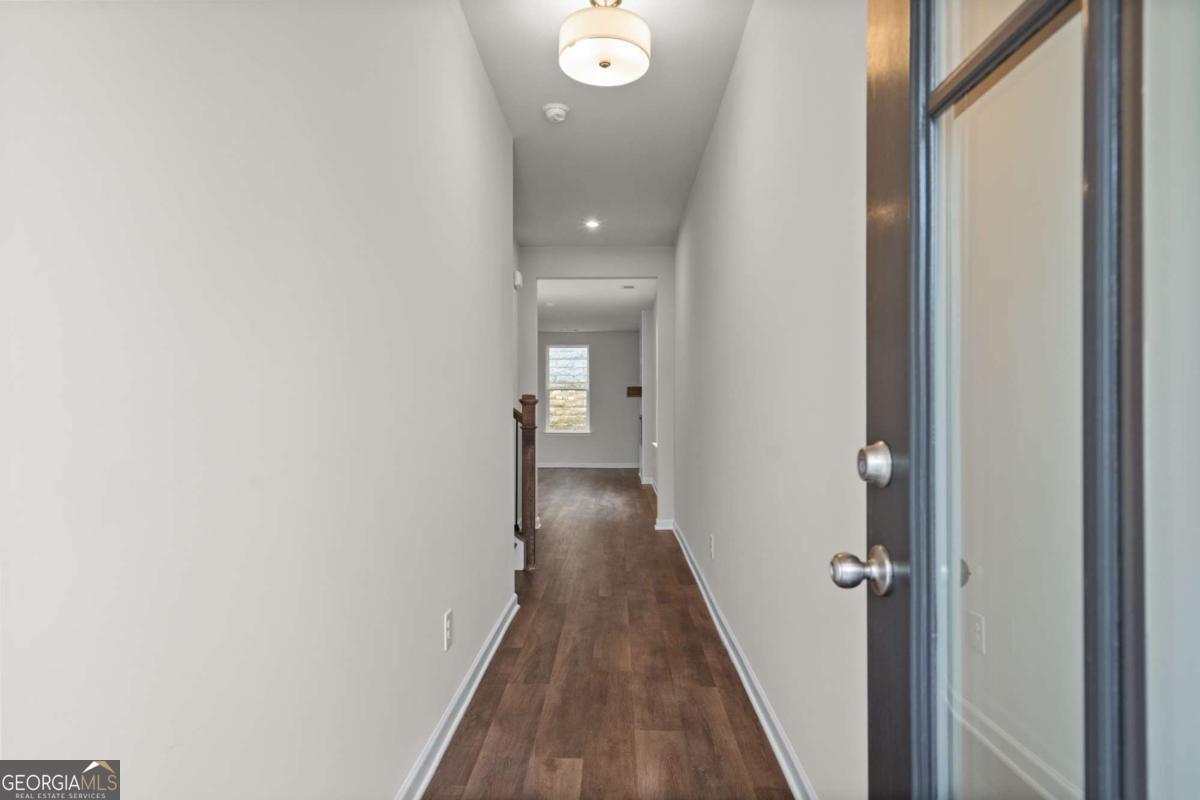 706 Smokey Quartz Way Kennesaw, GA 30144 - Photo 2 of 35 a view of a hallway with wooden floor