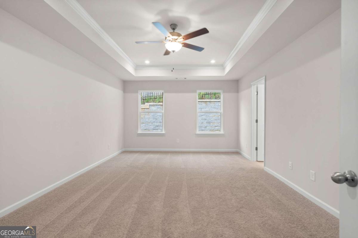 706 Smokey Quartz Way Kennesaw, GA 30144 - Photo 21 of 35 an empty room with windows and fan