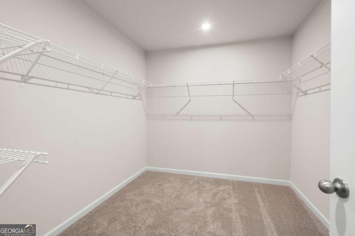 706 Smokey Quartz Way Kennesaw, GA 30144 - Photo 23 of 35 a view of a room with racks on the wall
