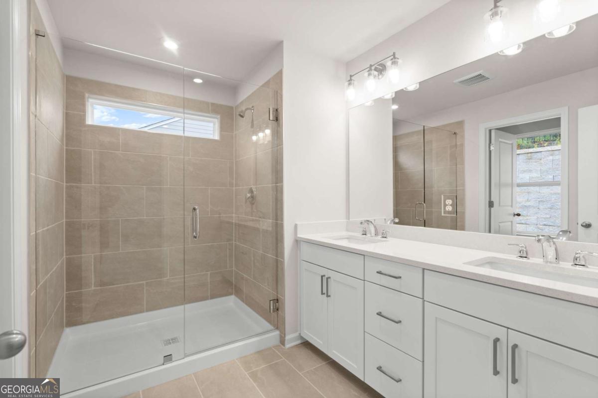706 Smokey Quartz Way Kennesaw, GA 30144 - Photo 24 of 35 a bathroom with a bathtub shower sink vanity and mirror