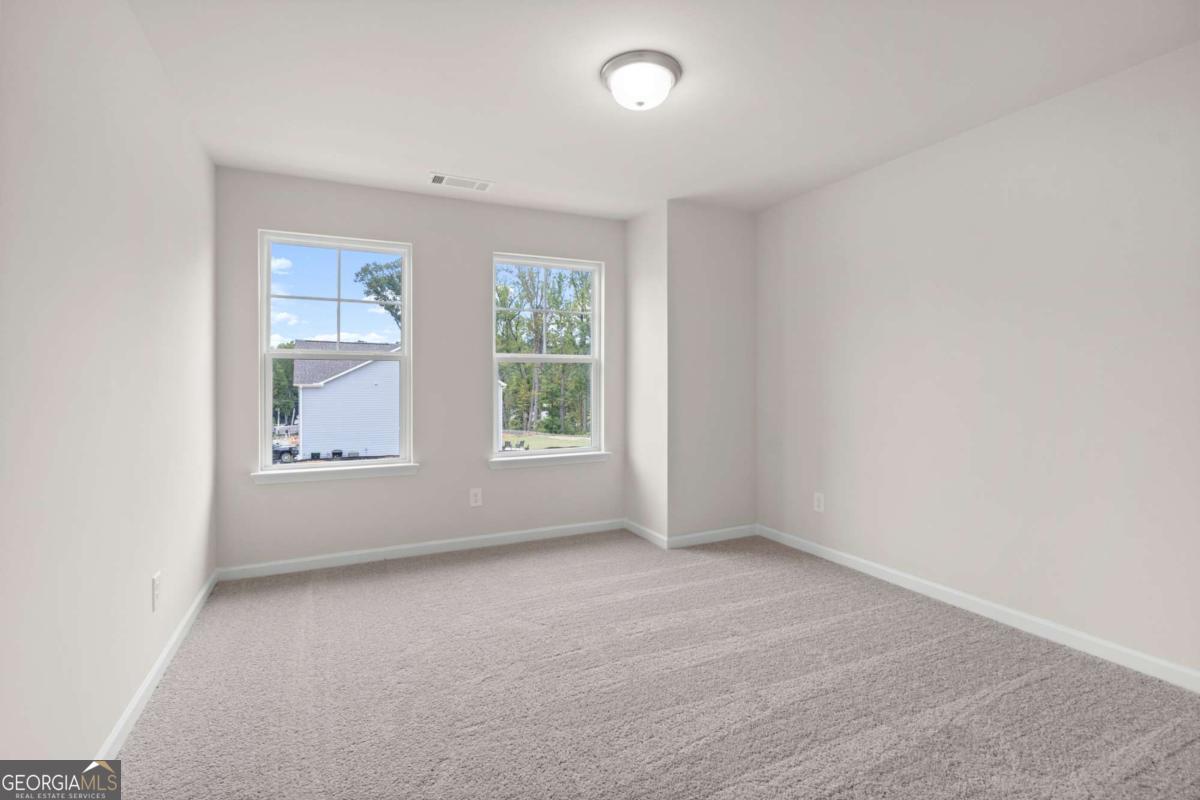 706 Smokey Quartz Way Kennesaw, GA 30144 - Photo 27 of 35 an empty room with windows