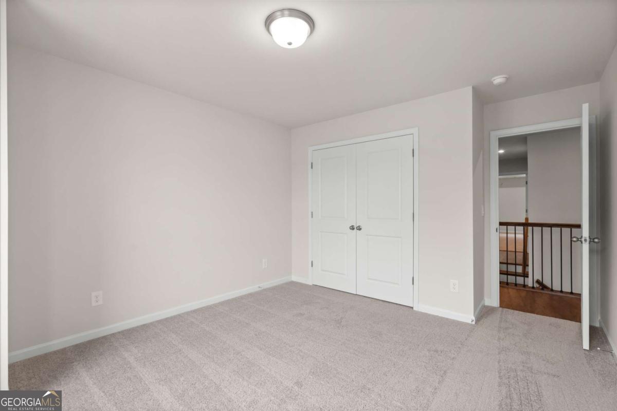 706 Smokey Quartz Way Kennesaw, GA 30144 - Photo 28 of 35 an empty room with closet area