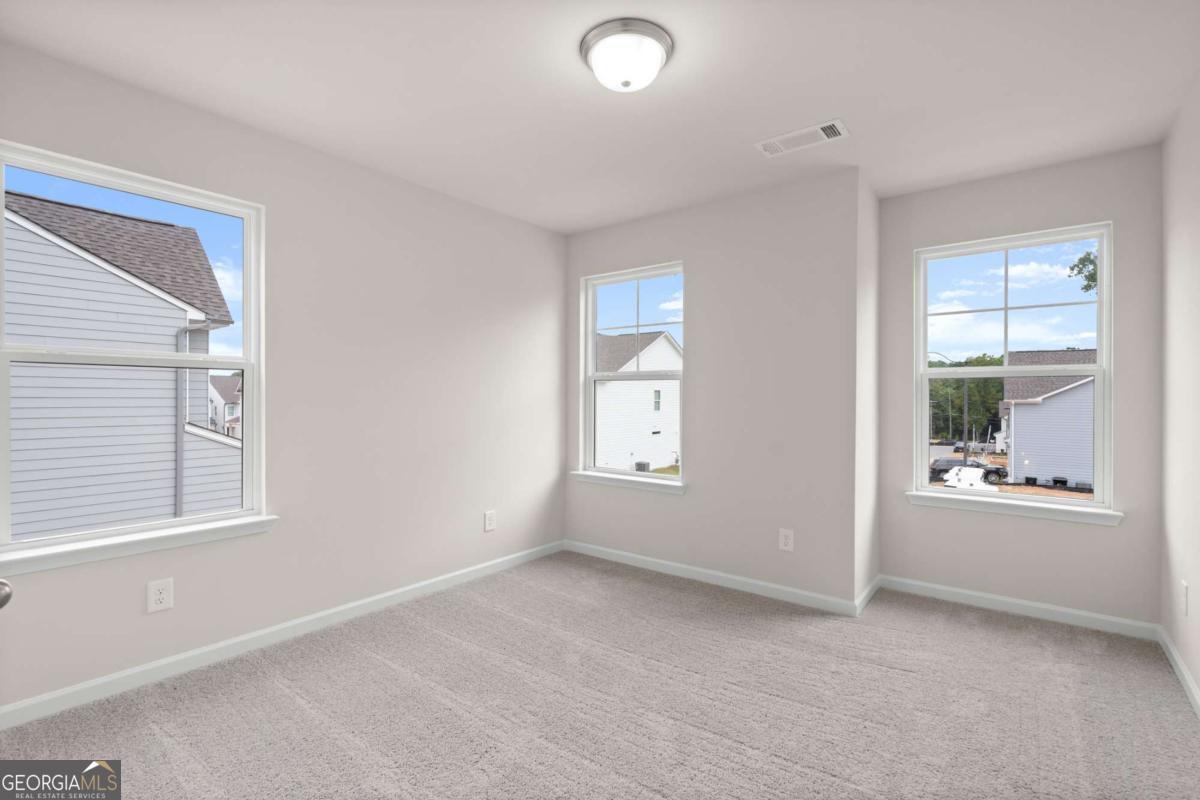 706 Smokey Quartz Way Kennesaw, GA 30144 - Photo 29 of 35 an empty room with windows and closet