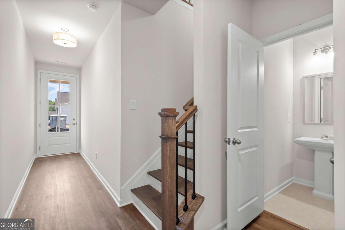 706 Smokey Quartz Way Kennesaw, GA 30144 - Photo 3 of 35 a view of a hallway with wooden floor and workspace