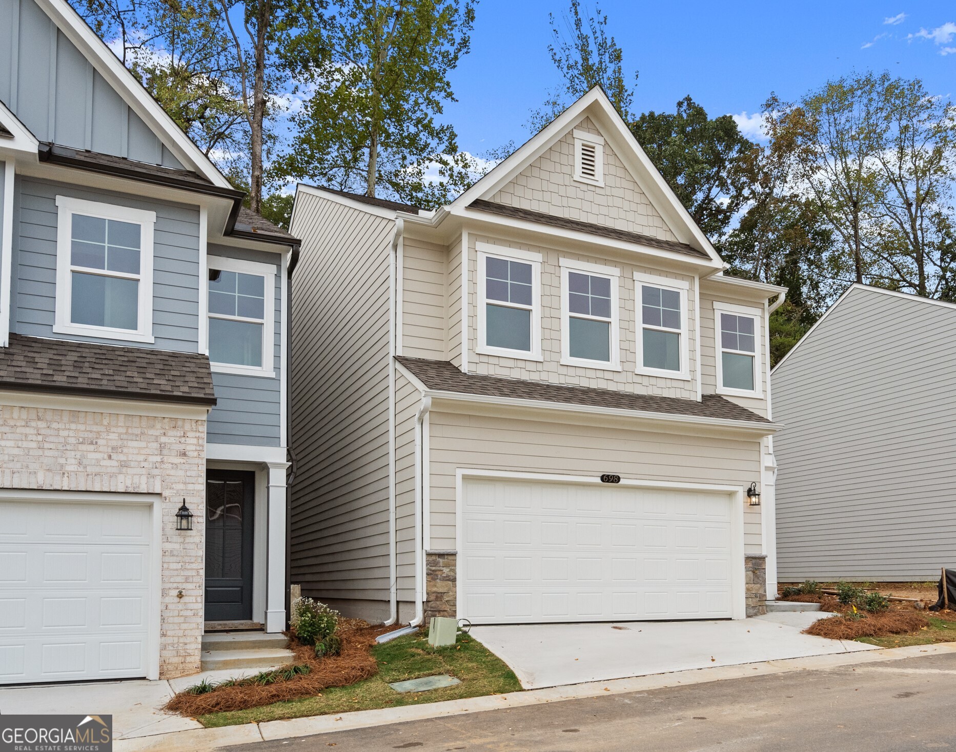 706 Smokey Quartz Way Kennesaw, GA 30144 - Photo 34 of 35 a front view of a house with a yard and garage