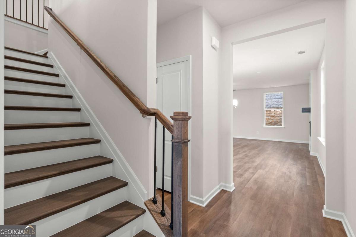706 Smokey Quartz Way Kennesaw, GA 30144 - Photo 4 of 35 a view of a hallway with wooden floor and entryway
