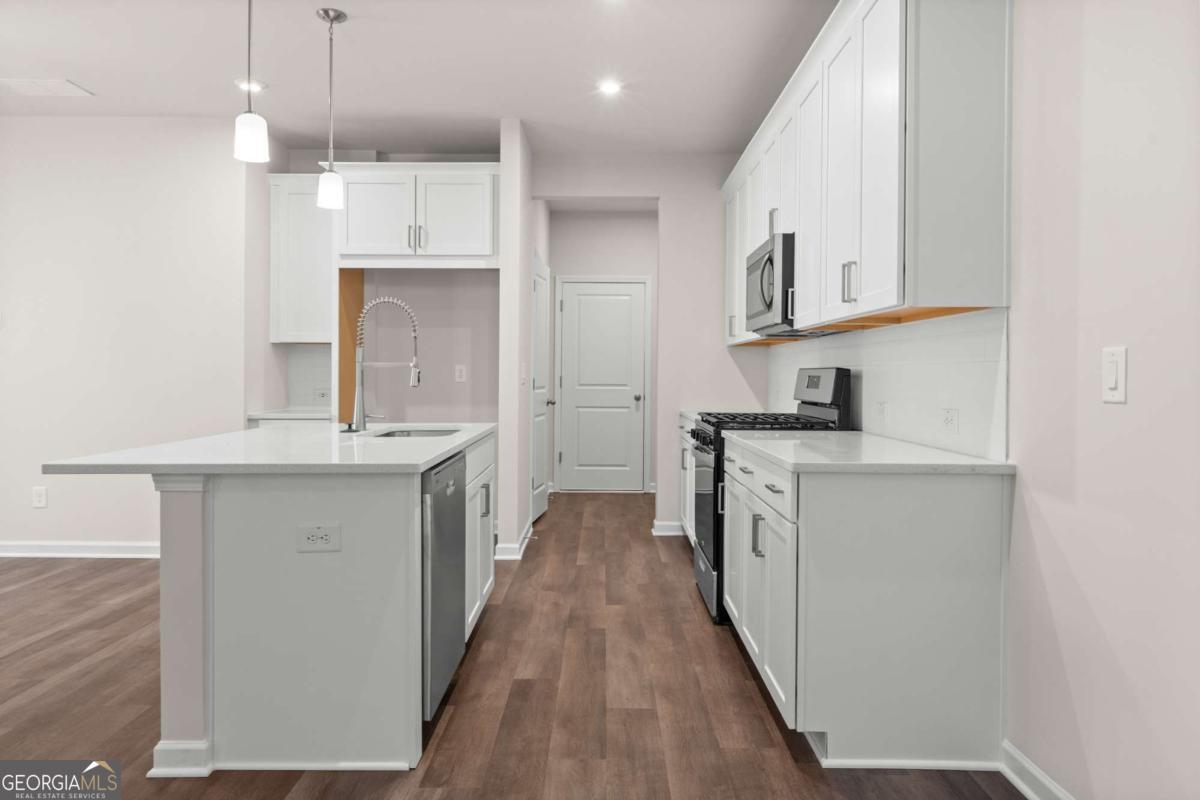 706 Smokey Quartz Way Kennesaw, GA 30144 - Photo 10 of 35 a kitchen with white cabinets and sink