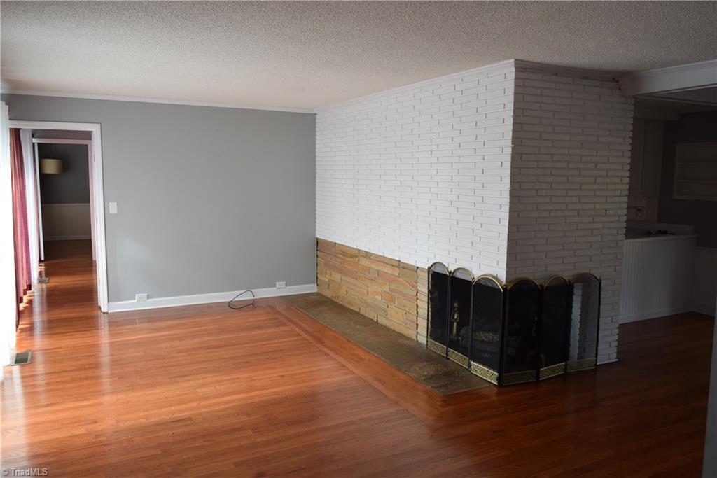 121 Oaklawn Road Mount Airy, NC 27030 - Photo 5 of 21 Living room with beautifully refinished hardwood floors. Two sided fire place with gas logs.