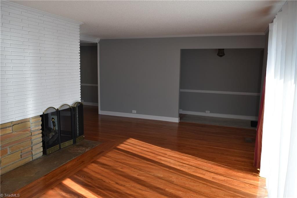 121 Oaklawn Road Mount Airy, NC 27030 - Photo 7 of 21 Large living room with two sided fireplace with gas logs