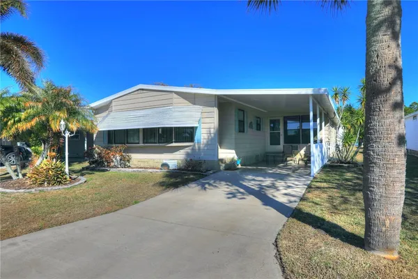 a front view of a house with yard patio and glass windows