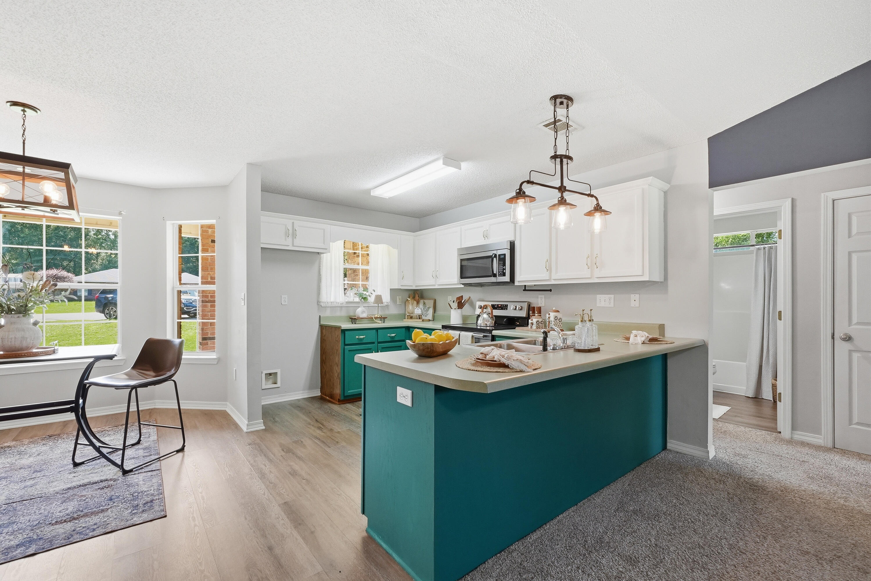 3033 Cabela Lane Crestview, FL 32539 - Photo 11 of 32 a room with stainless steel appliances kitchen island a table and chairs in it