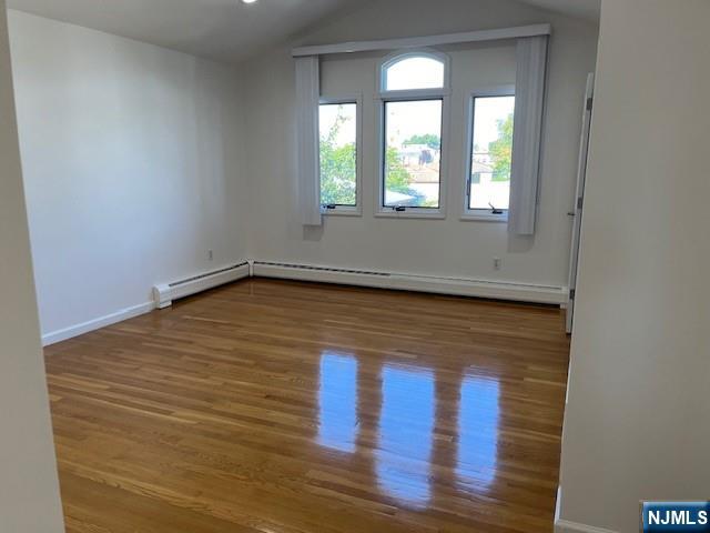 2440 B 3rd Street Fort Lee, NJ 07024 - Photo 13 of 16 a view of an empty room with wooden floor and a window