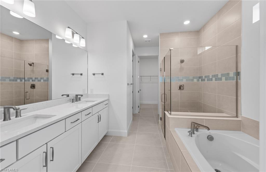 42544 Adirondack Drive Punta Gorda, FL 33982 - Photo 20 of 29 a bathroom with a double vanity sink mirror double and bathtub