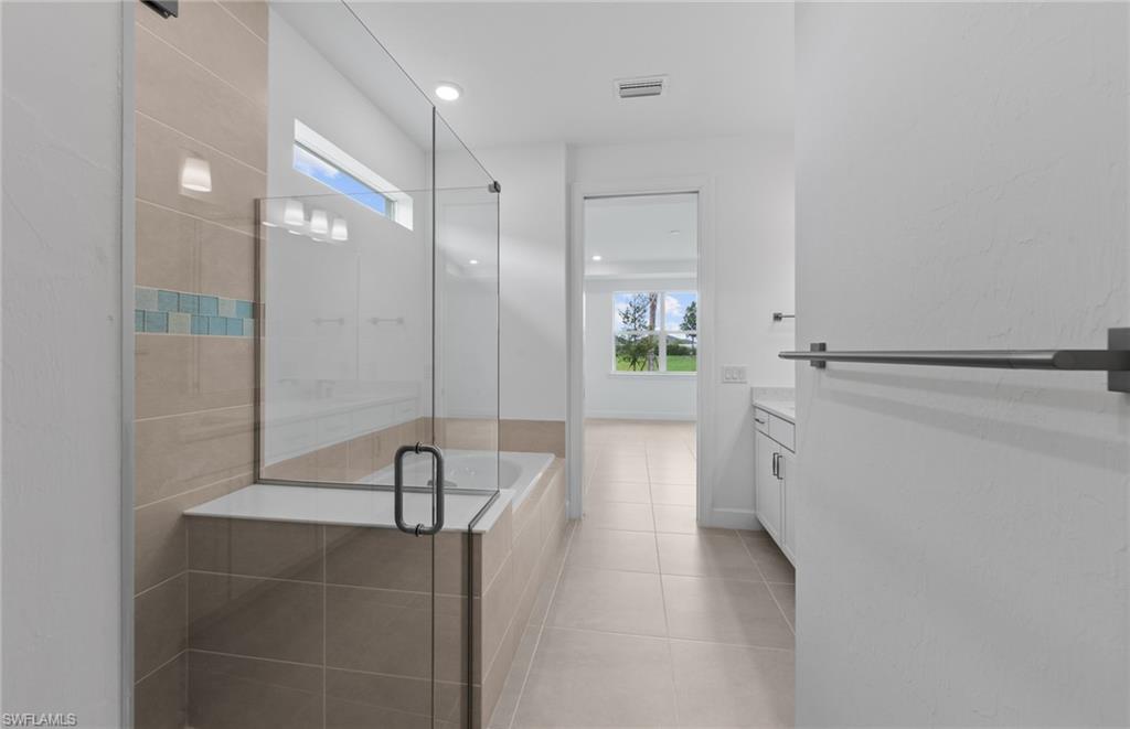 42544 Adirondack Drive Punta Gorda, FL 33982 - Photo 21 of 29 a bathroom with a bathtub and a shower