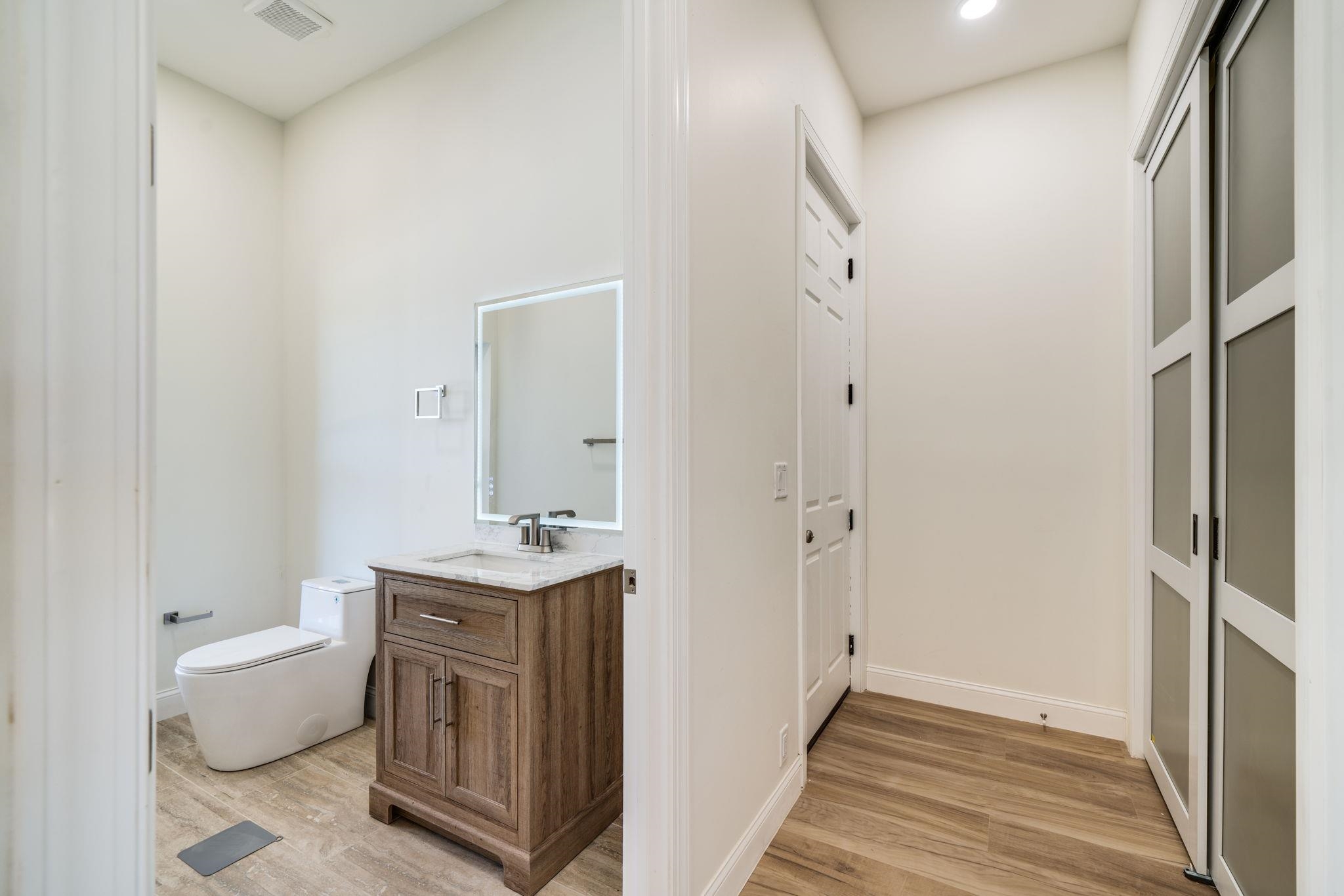 5145 Sycamore Ridge Road Belvidere, IL 61008 - Photo 36 of 57 a bathroom with a granite countertop sink a toilet a mirror and shower