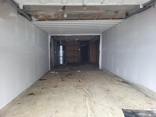 a view of a hallway with wooden floors