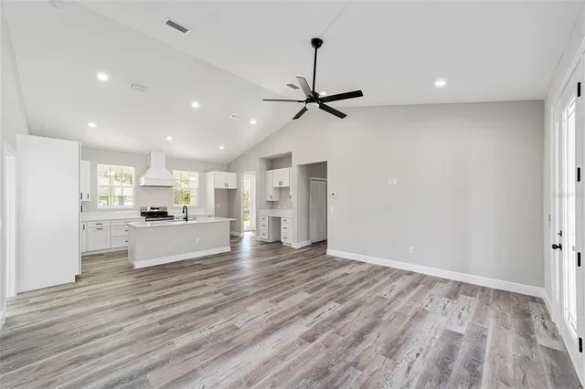 a view of a kitchen with a sink and wooden floor