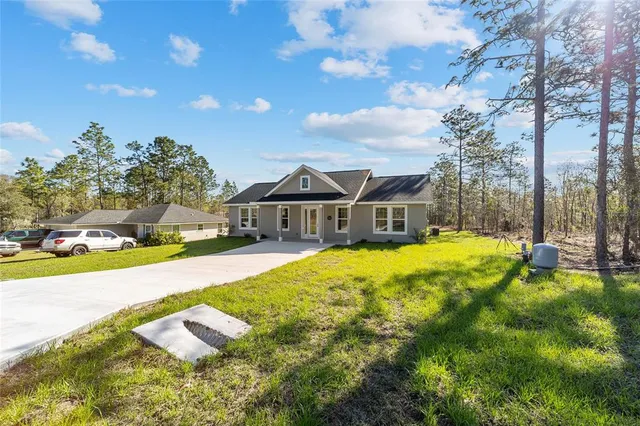 a view of a house with swimming pool and sitting area