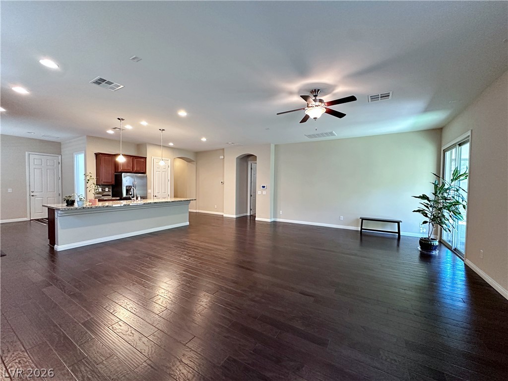 71 Newton Ridge Way Las Vegas, NV 89183 - Photo 11 of 40 Rich hardwood floors unite an open-concept living space with a well-appointed kitchen.