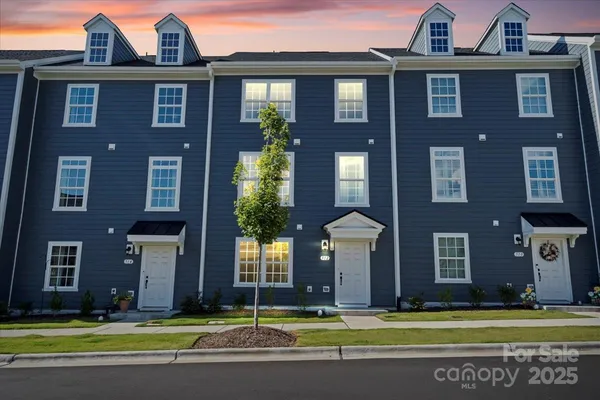 a view of a brick building next to a yard