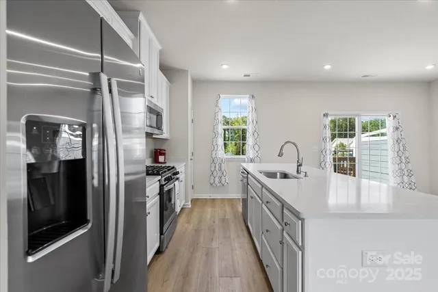 a kitchen with a sink and stainless steel appliances