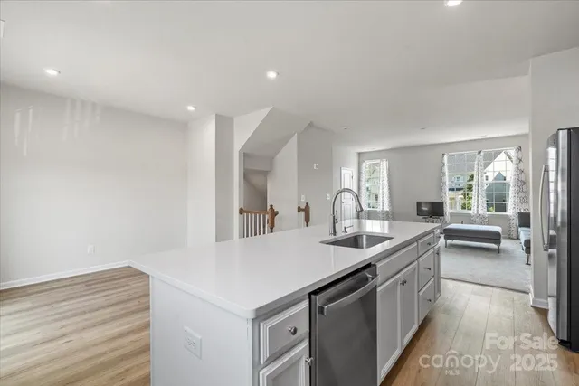 a kitchen with a sink and a refrigerator