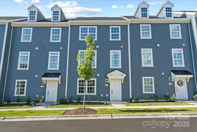 a view of a brick building next to a yard