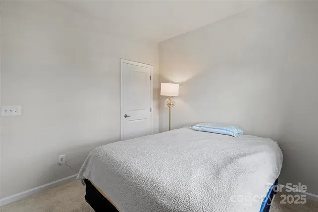 a bedroom with a bed and a night stand