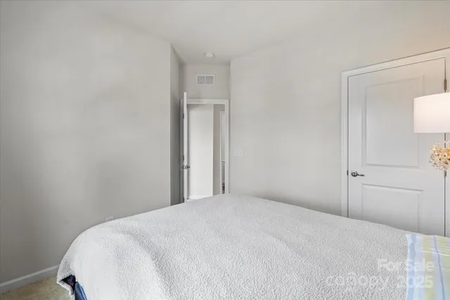a bedroom with a bed and a mirror